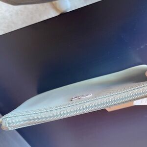 Blue Lacoste wristlet